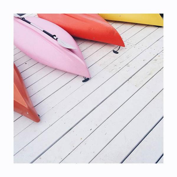 Pink and orange kayaks on white wood boards. Photo print by Instagrammer and editorial photographer Lisa Dieder.  This print and another 11 for sale on the Impressed Print Shop