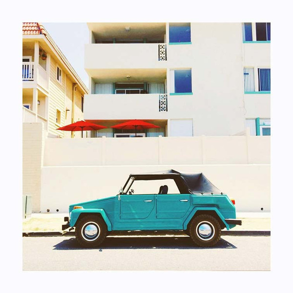 Turquoise Volkswagen rabbit against beige apartment buildings. Photo print by Instagrammer and westcoaster Arielle Vey.  This print and another 11 for sale on the Impressed Print Shop