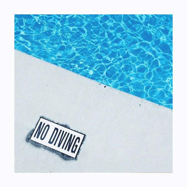 Triangular shot of a blue pool, with No Diving sign. Photo print by Instagrammer and blogger @anyeske.  This print and another 11 for sale on the Impressed Print Shop.
