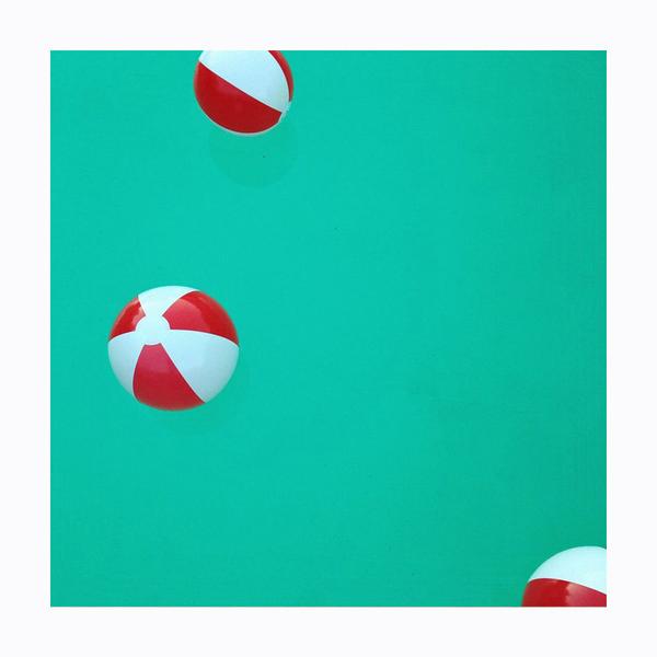 Beach balls on turquoise background. Photo print by Instagrammer and lifestyle photographer Leela Cyd.  This print and another 11 for sale on the Impressed Print Shop