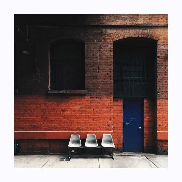 3 chairs on red brick wall. Photo print by Instagrammer and Toronto-based Genuine Lam.  This print and another 11 for sale on the Impressed Print Shop