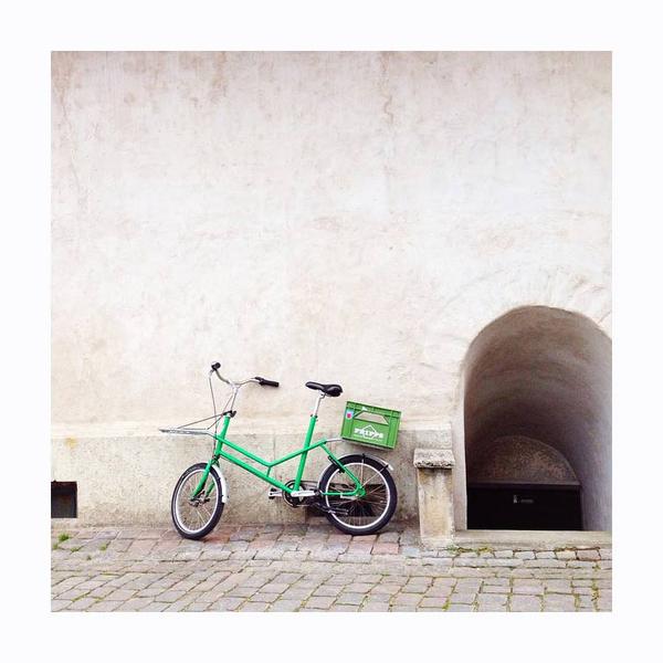 Green bicycle on beige character wall. Photo print by Instagrammer Chelsea Fuss, living in coastal England.  This print and another 11 for sale on the Impressed Print Shop